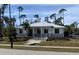 Contemporary house with metal roof, light gray accents, and steps leading to the entrance at 1209 Nordendale Blvd, North Port, FL 34288