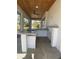 Covered patio with outdoor kitchen featuring a built-in bar and grill at 1209 Nordendale Blvd, North Port, FL 34288