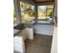 Covered patio with outdoor kitchen featuring a built-in grill and bar at 1209 Nordendale Blvd, North Port, FL 34288