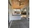 Covered patio with outdoor kitchen featuring a built-in bar and ceiling fan at 1209 Nordendale Blvd, North Port, FL 34288