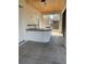 Covered patio with outdoor kitchen featuring a built-in bar and ceiling fan at 1209 Nordendale Blvd, North Port, FL 34288