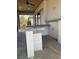 Covered patio with outdoor kitchen featuring a built-in bar and grill at 1209 Nordendale Blvd, North Port, FL 34288