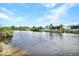 Serene view of a canal with lush vegetation and a boat dock at 15133 Amsterdam, Port Charlotte, FL 33981