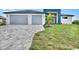 Modern two-story home with gray paver driveway and two-car garage at 15133 Amsterdam, Port Charlotte, FL 33981