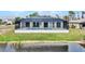 Back of house with pool and canal view at 15133 Amsterdam, Port Charlotte, FL 33981