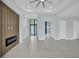 Spacious living area with modern fireplace and glass-walled office at 15133 Amsterdam, Port Charlotte, FL 33981