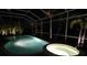 Relaxing pool and spa area at night with screened enclosure at 1637 Bobolink Ct, Punta Gorda, FL 33950