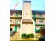 Condo building exterior, featuring a light-colored facade and lush landscaping at 175 Kings Hwy # Bldg 3 314, Punta Gorda, FL 33983