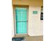 Light teal front door with glass panels and a welcoming doormat at 175 Kings Hwy # Bldg 3 314, Punta Gorda, FL 33983