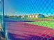 View of a tennis court through a chain link fence at 175 Kings Hwy # Bldg 3 314, Punta Gorda, FL 33983