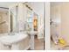Clean bathroom with pedestal sink, shower, and additional vanity area at 1801 Jamaica Way # 112, Punta Gorda, FL 33950