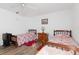 Well-lit bedroom featuring two twin beds and wood-look flooring at 1801 Jamaica Way # 112, Punta Gorda, FL 33950
