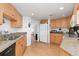 Efficient kitchen with ample cabinetry, granite countertops, and stainless steel appliances at 1801 Jamaica Way # 112, Punta Gorda, FL 33950