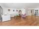 Bright living room with hardwood floors, comfy furniture, and access to a balcony at 1801 Jamaica Way # 112, Punta Gorda, FL 33950