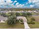 Aerial view of single-Gathering home with canal and neighborhood in background at 188 Broadmoor Ln, Rotonda West, FL 33947