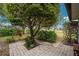 Landscaped backyard with brick paver patio and lush foliage at 188 Broadmoor Ln, Rotonda West, FL 33947