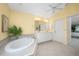 Elegant bathroom with a large soaking tub and double sink vanity at 188 Broadmoor Ln, Rotonda West, FL 33947