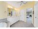 Bathroom with a double vanity and a view into the bedroom at 188 Broadmoor Ln, Rotonda West, FL 33947