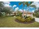 Single-story home with palm trees and manicured landscaping at 188 Broadmoor Ln, Rotonda West, FL 33947