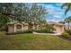 Single-story home with attached garage and lush landscaping at 188 Broadmoor Ln, Rotonda West, FL 33947