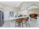 Modern kitchen with stainless steel appliances and breakfast bar at 188 Broadmoor Ln, Rotonda West, FL 33947