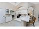 Bright kitchen with white cabinets, breakfast bar, and tile flooring at 188 Broadmoor Ln, Rotonda West, FL 33947