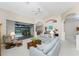 Living room with light blue sofas, wooden cabinet, and pool view at 188 Broadmoor Ln, Rotonda West, FL 33947