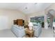Open living room with light blue sofas, wood coffee table, and view of pool at 188 Broadmoor Ln, Rotonda West, FL 33947