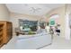 Spacious living room with light-colored sofas and access to the pool at 188 Broadmoor Ln, Rotonda West, FL 33947