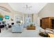 Spacious living room with light-colored sofas, built-in shelving, and pool access at 188 Broadmoor Ln, Rotonda West, FL 33947