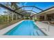 Enclosed rectangular pool with a view of lush landscaping at 188 Broadmoor Ln, Rotonda West, FL 33947