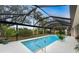Relaxing screened-in pool area with lush landscaping at 188 Broadmoor Ln, Rotonda West, FL 33947