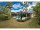 Screened-in pool with lush landscaping at 188 Broadmoor Ln, Rotonda West, FL 33947