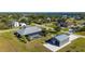 Aerial view showcasing a house with a pool, detached garage, and spacious yard at 2329 Pinellas Dr, Punta Gorda, FL 33983