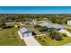 Aerial view of a house with a pool, detached garage, and large yard at 2329 Pinellas Dr, Punta Gorda, FL 33983