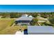 Aerial view of house, pool, and detached garage in a residential area at 2329 Pinellas Dr, Punta Gorda, FL 33983