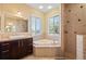 Bathroom with corner soaking tub and walk-in shower at 2329 Pinellas Dr, Punta Gorda, FL 33983