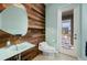 Modern powder room with unique sink and wood wall at 2329 Pinellas Dr, Punta Gorda, FL 33983