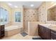 Spa-like bathroom with soaking tub, walk-in shower, and double vanity at 2329 Pinellas Dr, Punta Gorda, FL 33983
