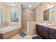 Spa-like bathroom with soaking tub, walk-in shower, and double vanity at 2329 Pinellas Dr, Punta Gorda, FL 33983