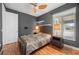 Cozy bedroom featuring wood floors, a ceiling fan, and ample natural light at 2329 Pinellas Dr, Punta Gorda, FL 33983