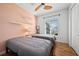 Cozy bedroom with two twin beds, ceiling fan, and built-in shelves at 2329 Pinellas Dr, Punta Gorda, FL 33983