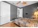 Bright bedroom with wood floors, ceiling fan, and built-in shelving at 2329 Pinellas Dr, Punta Gorda, FL 33983