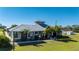Gray metal roof house with lush landscaping, large driveway and detached garage at 2329 Pinellas Dr, Punta Gorda, FL 33983