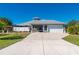 Gray house with white trim, two-car garage and manicured lawn at 2329 Pinellas Dr, Punta Gorda, FL 33983