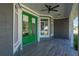 Covered porch with green double doors and ceiling fan at 2329 Pinellas Dr, Punta Gorda, FL 33983