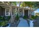 Covered porch with green double doors and tropical landscaping at 2329 Pinellas Dr, Punta Gorda, FL 33983