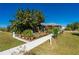 Landscaped front yard featuring a pergola and walkway at 2329 Pinellas Dr, Punta Gorda, FL 33983
