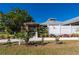 Landscaped front yard with a pergola and walkway at 2329 Pinellas Dr, Punta Gorda, FL 33983