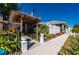 Landscaped front yard with pergola and walkway at 2329 Pinellas Dr, Punta Gorda, FL 33983